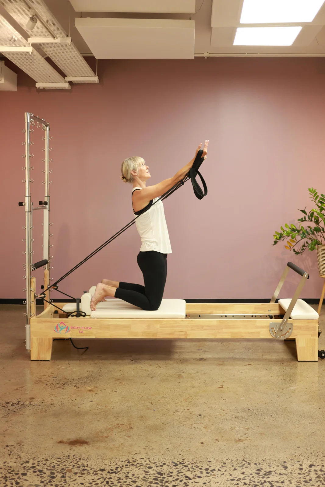 Kneeling strap work on the reformer and tower