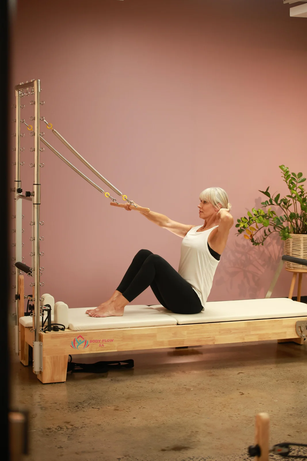 Nadine guiding strap work on the reformer