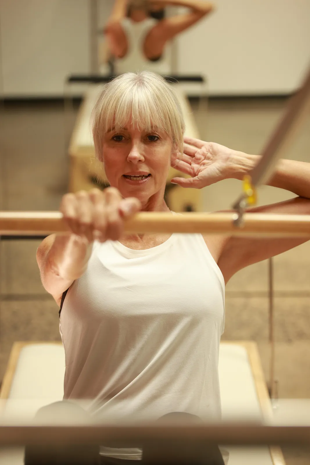 Nadine working at the reformer bar in the studio