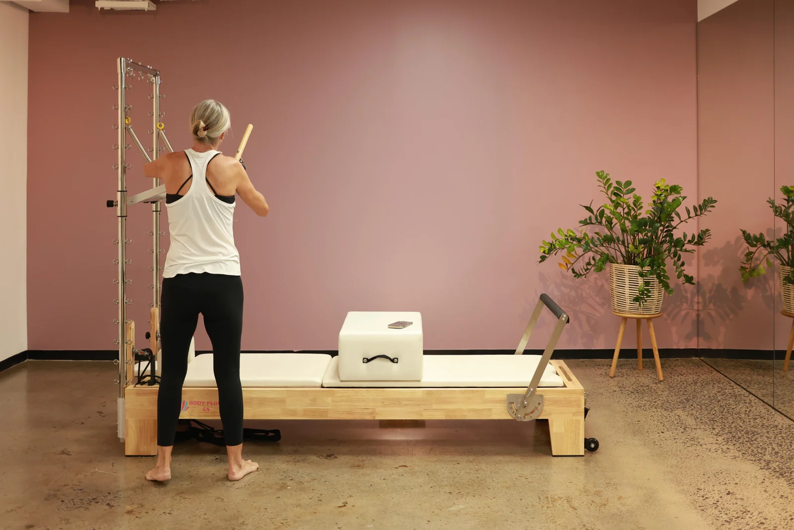 Pilates practice in the warm pink studio