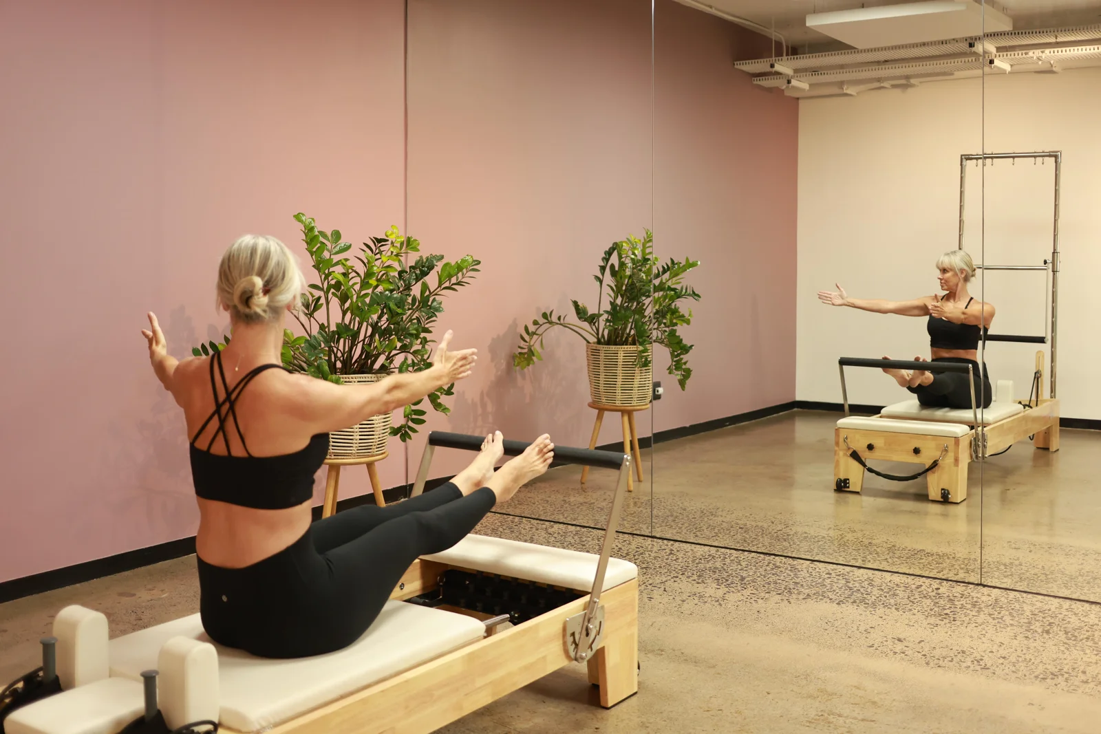 Pilates strap work reflected in the studio mirror